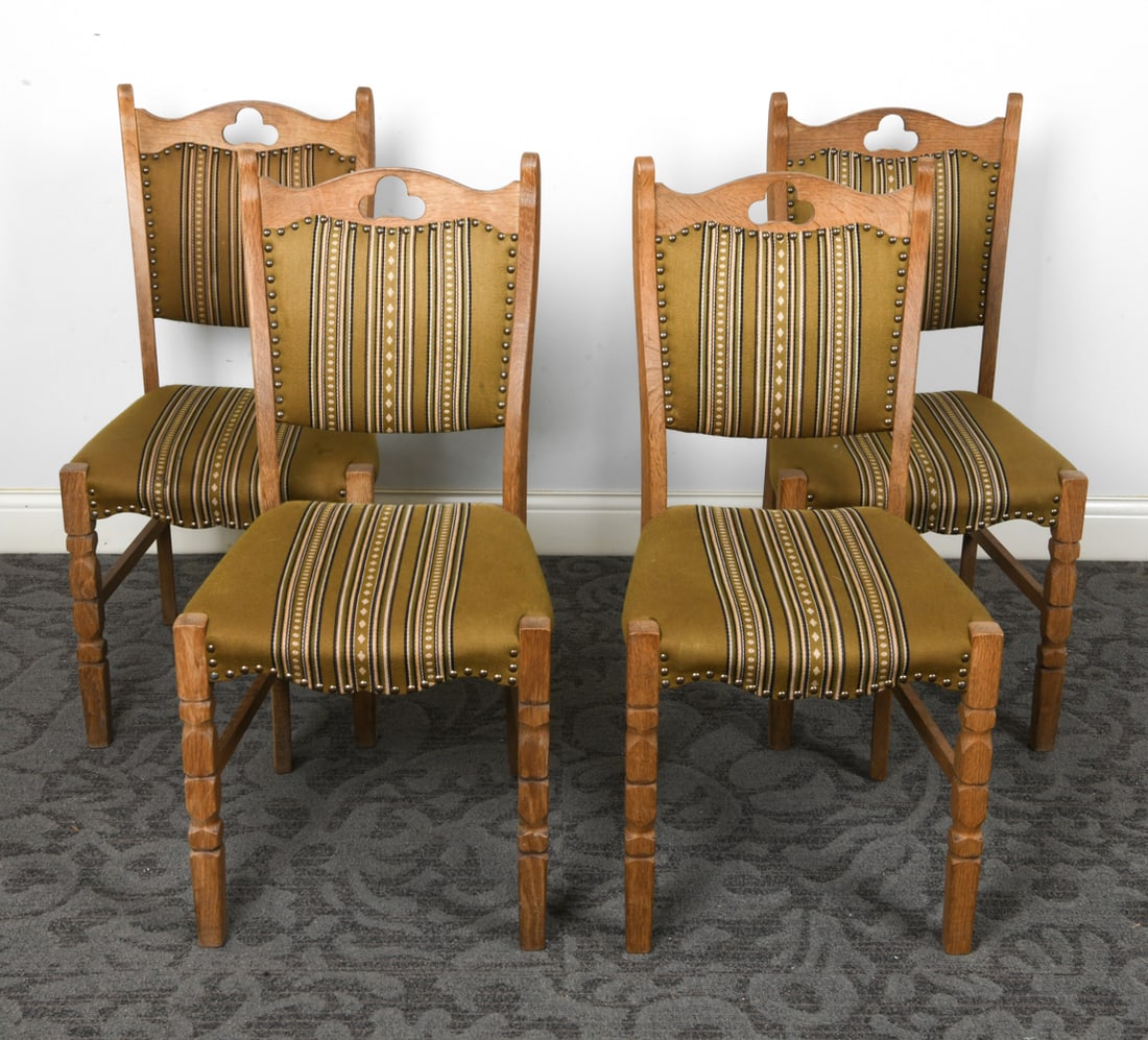 (4) HENNING KJAERNULF DANISH OAK DINING CHAIRS: Oak frames with turned legs and trefoil cut-out to seat backs. Green patterned wool upholstery with brass tacks accents. Denmark, circa 1970s. Dimensions: H 37" x W 15.5" x D 17.5" x SH 18".