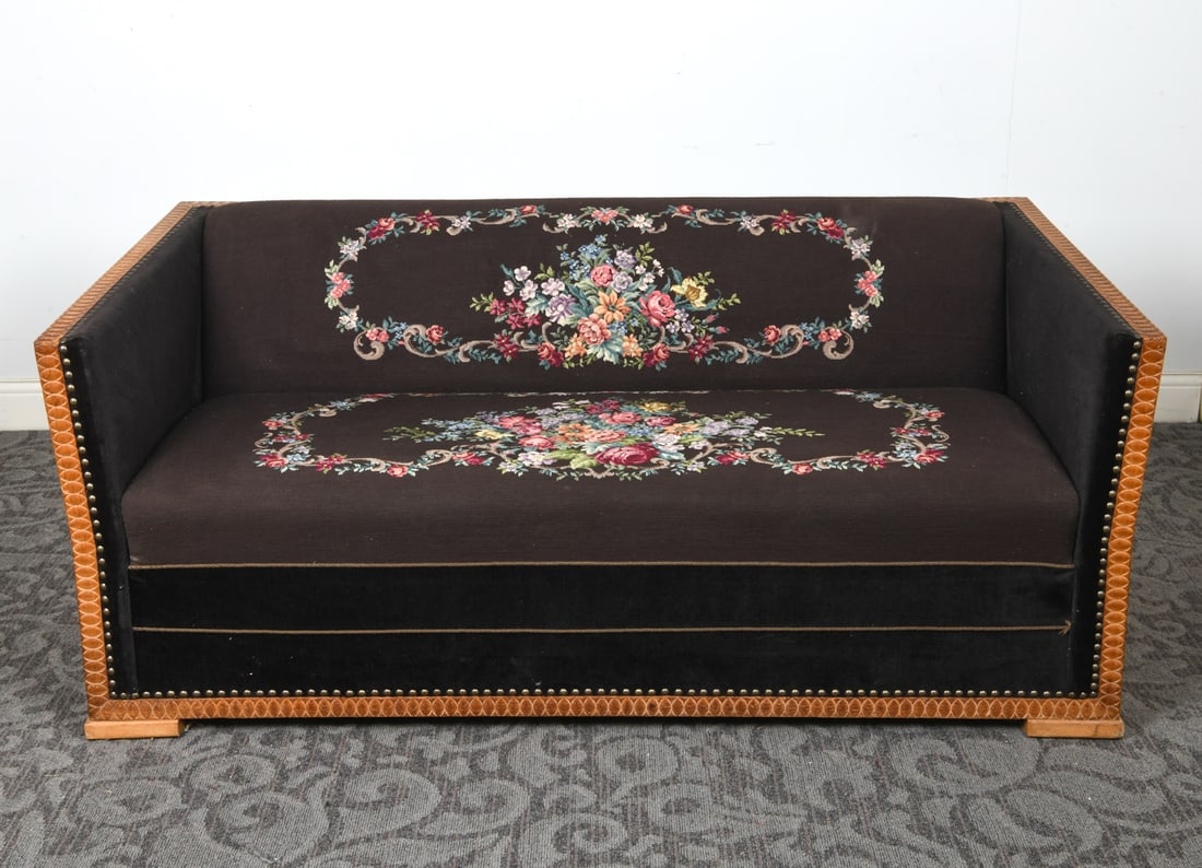 SCANDINAVIAN NEEDLEPOINT & OAK SOFA DAYBED C 1960S: Oak frame with carved decoration. Wool upholstery with needlepoint floral decoration. Seat folds out into full size bed. Pine side and legs to fold-out bed. Scandinavian, circa 1960s. Dimensions: H