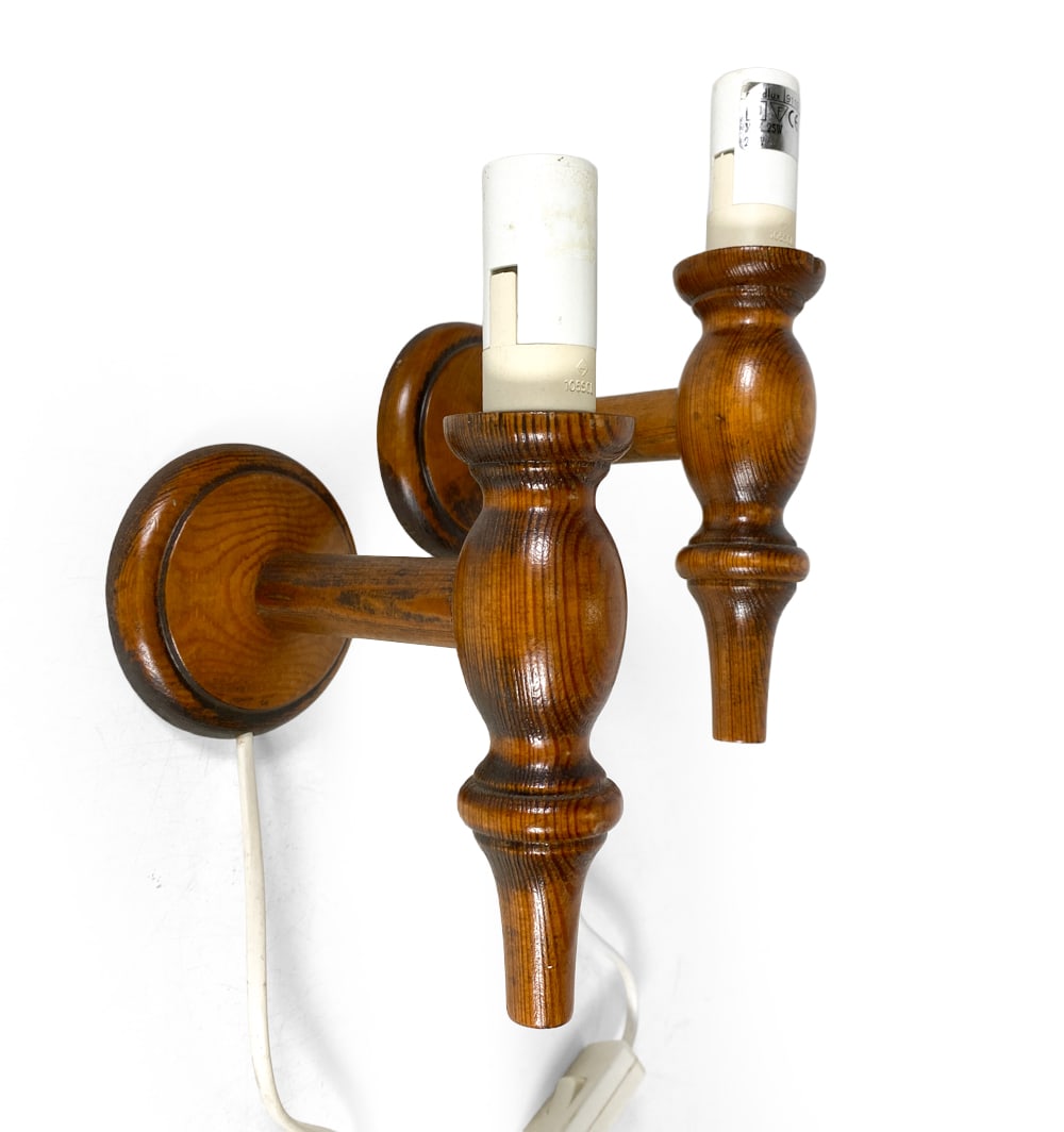 PAIR OF DANISH PINE WALL SCONCES C. 1970S: Pair of turned pine wall sconces. Denmark, circa 1970s. Dimensions: H 7.75" x W 3.25" x D 5.25". Conditions: Wear consistent with age and use, wiring untested, European plugs. DMU148