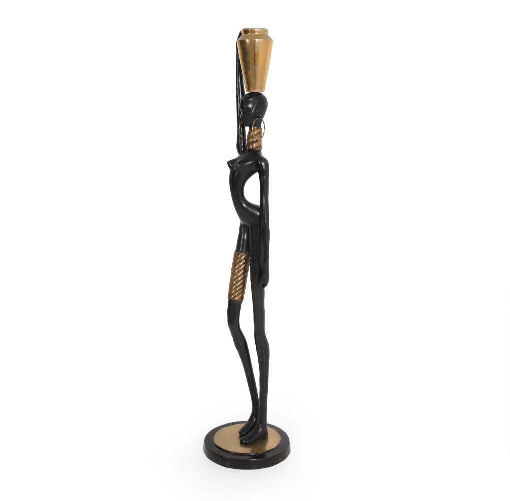 STYLE OF HAGENAUER LARGE BRONZE NDEBELE SCULPTURE: Tall bronze sculpture with brass details depicting an African Ndebele woman with a jug on her head and elegant brass accessories depicting gold. Apparently unmarked. Dimensions: H 66" x D 14" Conditio