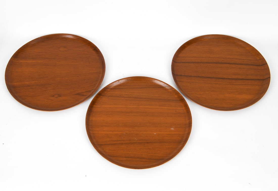 GEORGE NELSON FOR HERMAN MILLER TEAK TRAYS: Mid-century, including a circular tray with raised edge. Circa 1960s. Dimensions: Dia 18" Condition: Wear consistent with age and use, including scratches and surface marks. Chips to edge and discolor