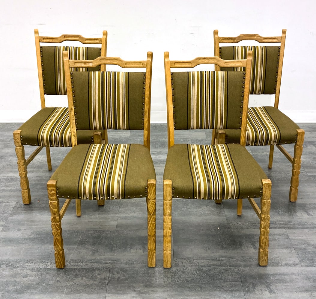 (6) HENNING KJAERNULF DANISH OAK DINING CHAIRS: Oak frames with turned legs. Green wool upholstery. Brass tacks accent. Recessed carvings to frame. Denmark, circa 1970s. Dimensions: H 37" x W 19" x D 17.25" x SH 17.75". Condition: Wear consistent w