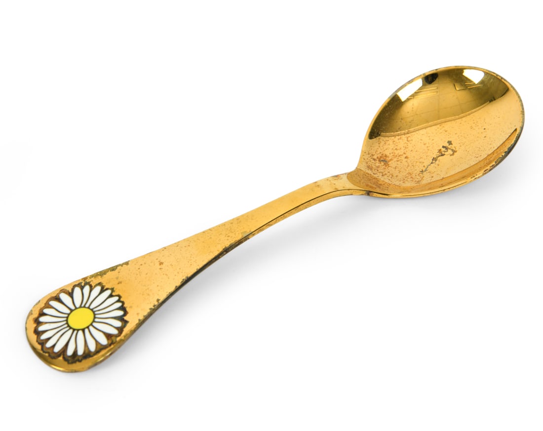 GEORG JENSEN GOLD PLATED STERLING SILVER SPOON: From the Annual Floral Series. Titled 'Oseye Daisy'. Marked on back. Released 1987. In original box. personalized engraving. Total Weight: 1.41 ozt. Dimensions: L 6". Boz L 8.25". Condition: Rubs and