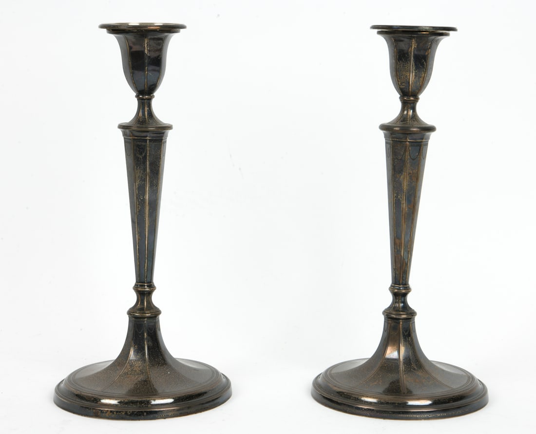 PAIR OF TIFFANY & CO. STERLING SILVER CANDLESTICKS: Retailed by Tiffany, originally designed by John Green & Co. Marked to bases. Weighted bases. Early 20th century. Dimensions: H 11.75" x Dia. 5.75". Condition: Tarnish and rubs. Wear consistent with a