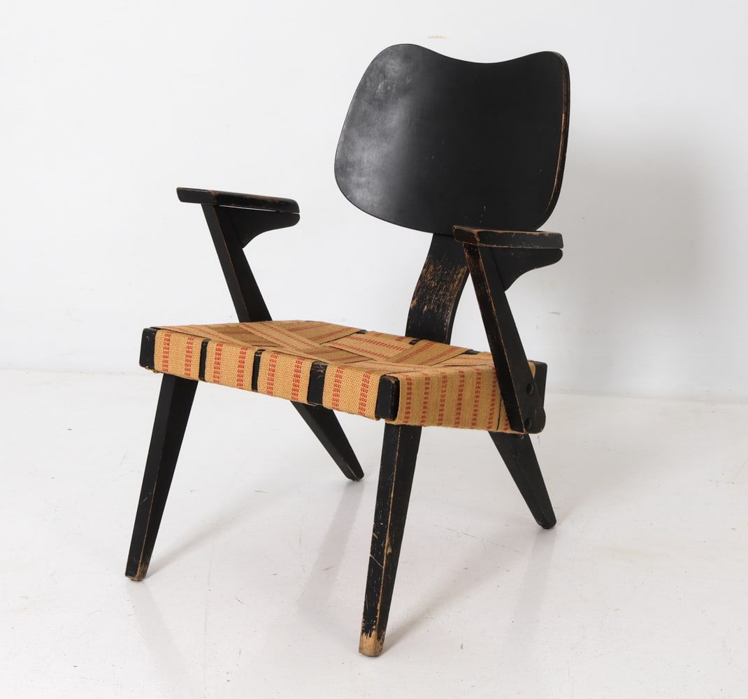 RUSSELL SPANNER "RUSPAN" ARM CHAIR C. 1950S: Birch wood frame with ebonized finish. Bent plywood backrest and angular armrest. Woven webbing seat in beige and orange pattern. Apparently unmarked. Canada, circa 1950s. Dimensions: H 29.5" x W 23" 