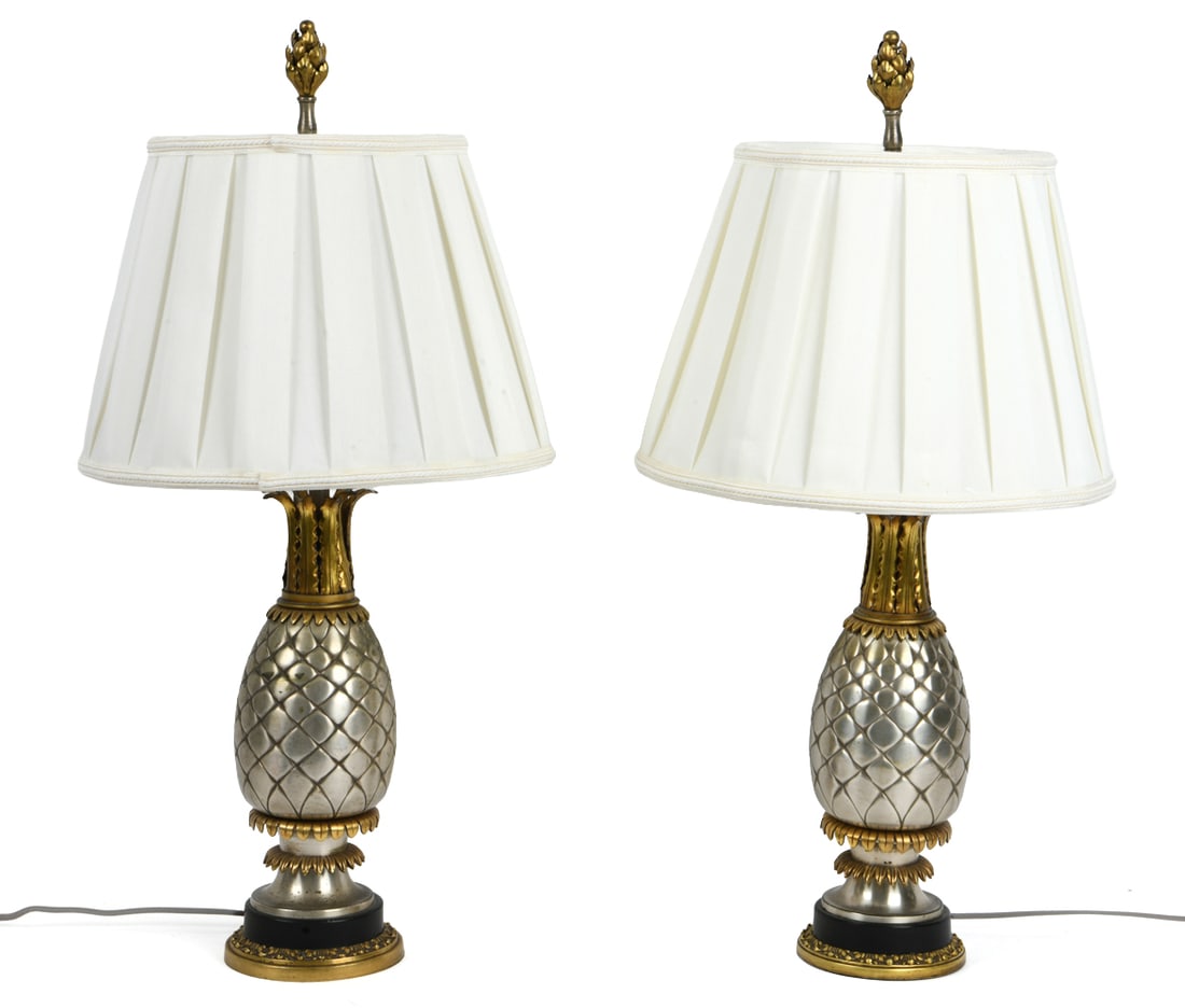 PAIR OF HOLLYWOOD REGENCY STYLE PINEAPPLE LAMPS: Pair of table lamps with metal bodies in shapes of pineapples. 20th century. Dimensions: H 27" x Dia. 13.75". Condition: Wiring untested. Scuffs and rubs to bodies. Few tears to shades inner lining.