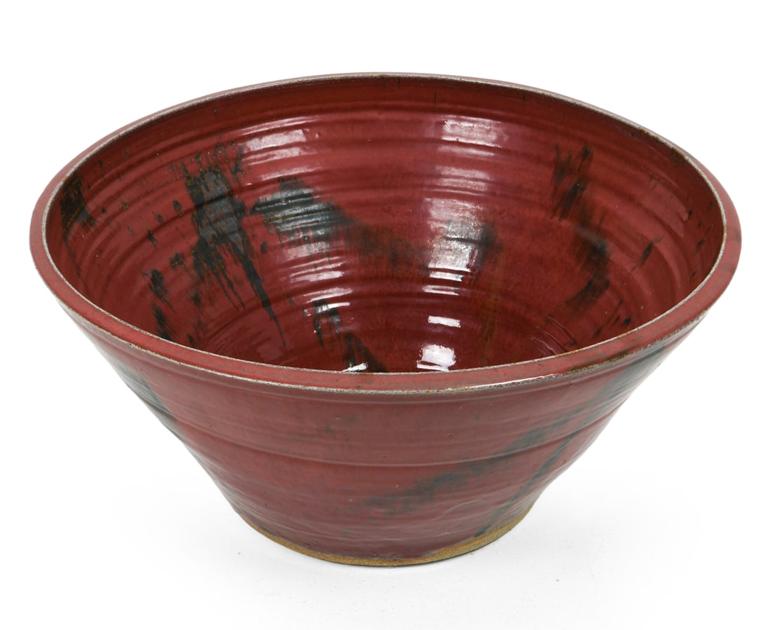 LARGE DECORATIVE CERAMIC BOWL: Large decorative ceramic bowl in red and black abstract design. Apparent possible signature under base. Dimensions: H 10.25" x Dia. 22.5". Condition: Faint scuffs, presents well overall.