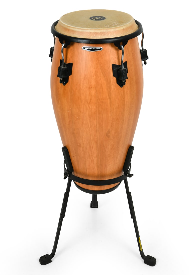 MEINL MARATHON CLASSIC SERIES CONGA DRUM: Conga drum in natural finish with steel stand. Dimensions: In Stand H 43" x Dia. 15.5". Drum H 30" x Dia. 14.5". Top Dia. 11.75". Condition: Scuffs and scratches to skin. Few small dings to sides.