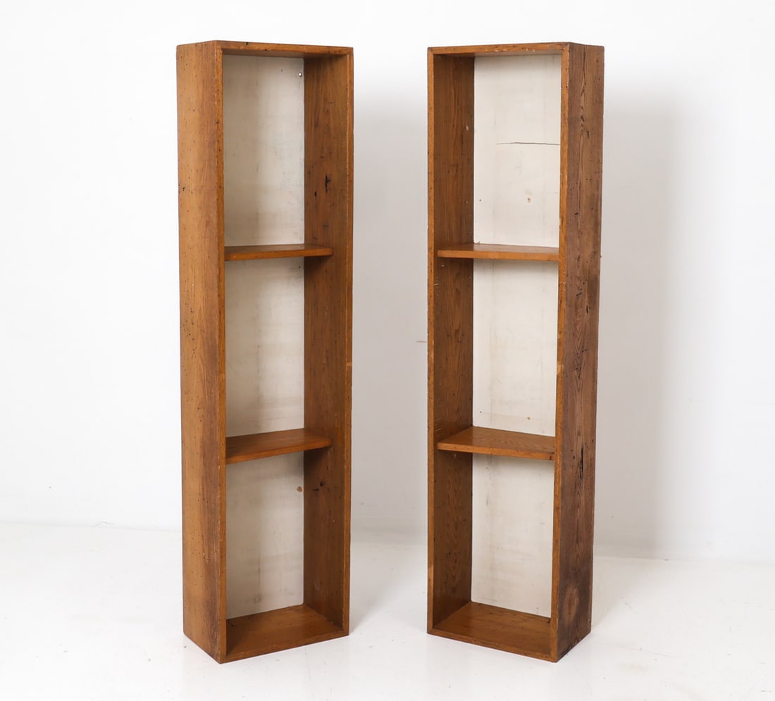 PAIR OF CHESTNUT BOOKCASE SHELVES C. 1950S: Pair of tall narrow bookcases in chestnut, featuring a slender, open three-shelf design. White painted finish to back of interiors. Circa 1950s. Dimensions: H 67" x W 16.5" x D 10.5". Condition: Evide