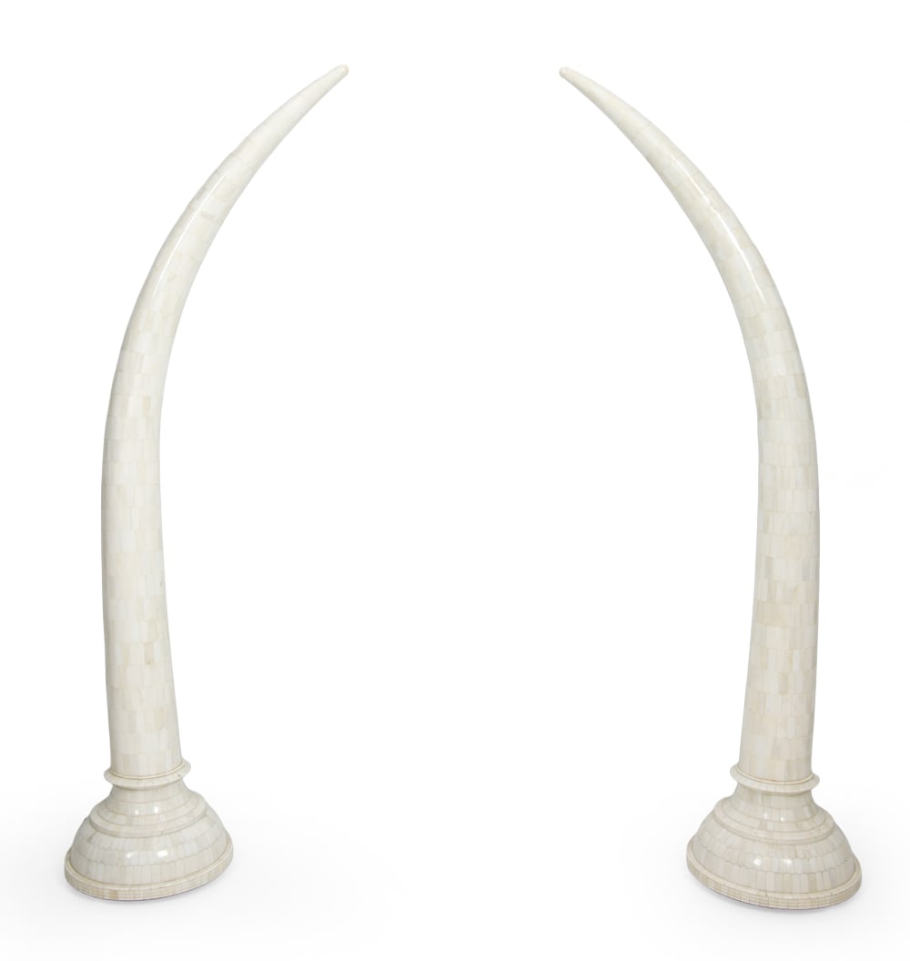 PAIR TESSELLATED BONE ELEPHANT TUSKS: Two faux elephant tusks crafted from wood with camel bone to surface in tessallated pattern. Dimensions: H 62.5" x W 22" x D 15". Condition: Light scuffs and few faint discolored spots. Wear consisten
