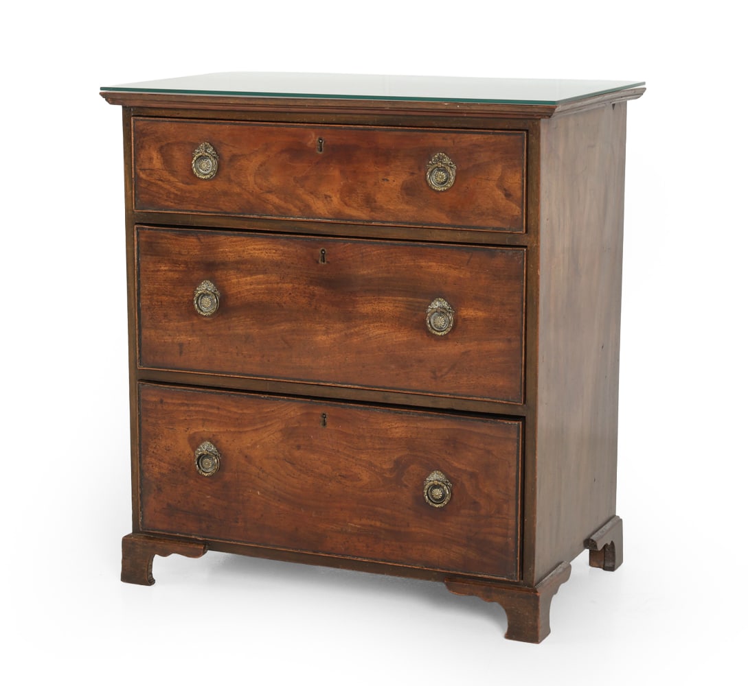 ANTIQUE GEORGIAN STYLE WALNUT CHEST OF DRAWERS: Chest of three drawers with brass circular pulls and centered keyholes. Bracket feet. Includes a glass top. 19th century. Dimensions: H 32" x W 30" x D 18" Condition: Wear consistent with age and use.