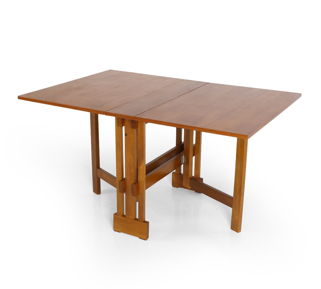 ATTR. ALDO JACOBER TEAK GATELEG DINING TABLE 1960S: Teak drop-leaf extending dining table with gatelog. Aldo Jacober's design was produced in Romania under license. Stamped "Made in Romania". Circa 1960s. Dimensions: 54? W x 36? D x 29? H (fully extend