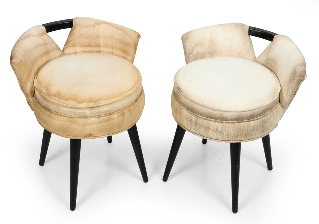 PAIR OF PAUL FRANKL FOR JOHNSON VANITY STOOLS: Two vanity stools designed by Paul Frankl and manufactured by Johnson Furniture Company. Lacquered wood legs and original upholstery. Production label marked underneath. Circa, 1950s. Dimensions: H 21