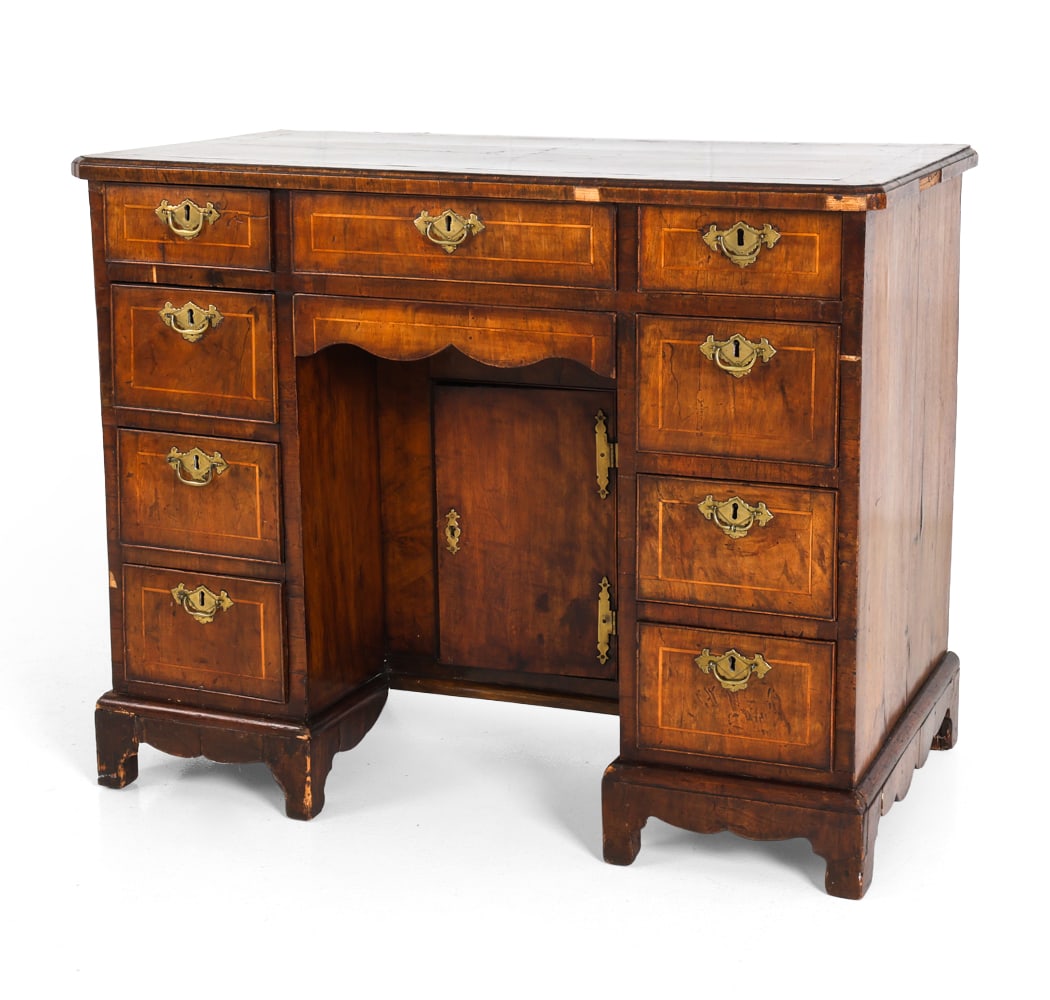 ANTIQUE GEORGE II WALNUT KNEEHOLE DESK: Walnut frame with inlays and brass handles and escutcheons. Rectangular top with drawers. Kneehole with curved apron above a recessed paneled door. On bracket feet. 18th century. Dimensions: H 31.5" x
