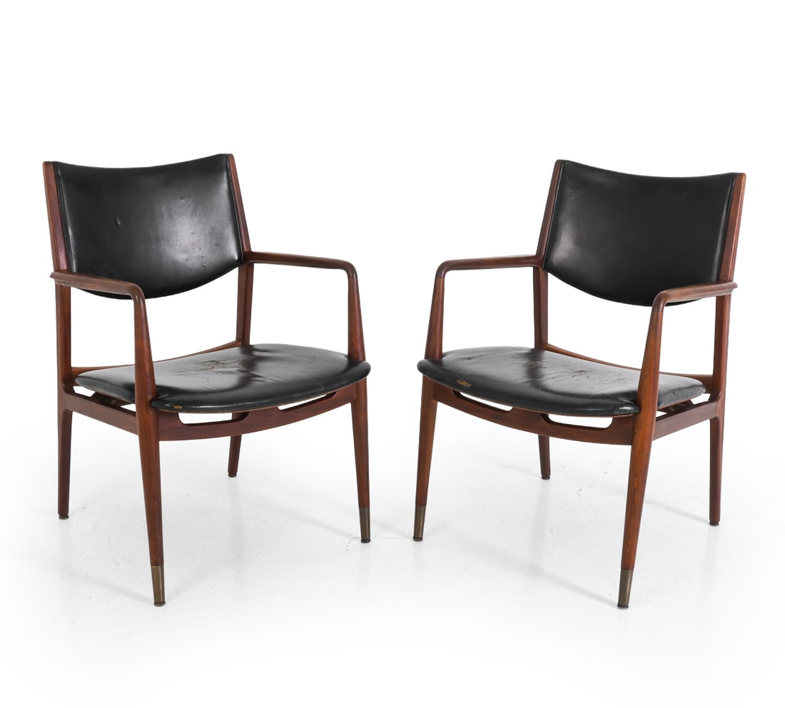 PAIR GEORGE REINOEHL FOR STOW & DAVIS ARMCHAIRS: Two armchairs designed by George Reinoehl for Stow & Davis. Walnut frame and leather upholstery. Front legs capped by brass sabots. Marked underneath. circa 1960s. Dimensions: H 34" x W 22.5" x D 23" 