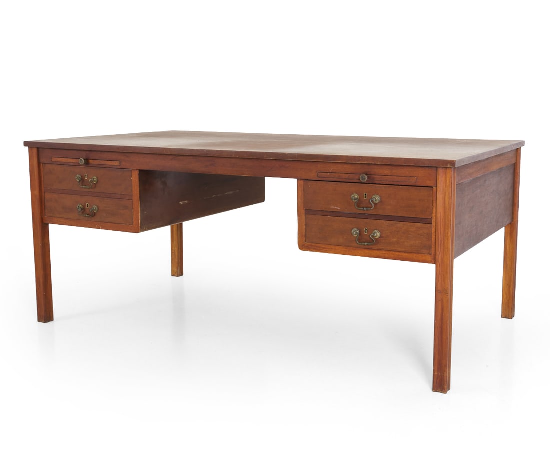 STYLE OF WANSCHER TEAK WRITING DESK C. 1950S: Two keys included. Writing desk with cabinets, drawers, and pull out writing trays. Brass pulls. Denmark, circa 1950s. Dimensions: H 30" x W 71" x D 30.5". Condition: Scuffs, scratches, dings. Chip to