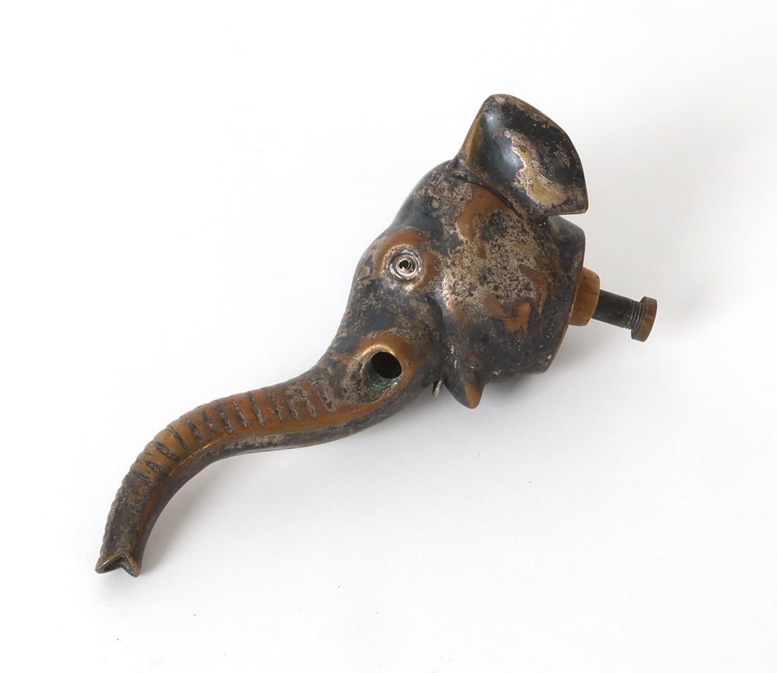 ANTIQUE SILVER ON COPPER ELEPHANT LIQUOR SPOUT: Silverplated copper elephant head used as decorative topper for a bottle, may be missing tusks Early 20th century. Dimensions: H 3" x W 2.5" x D 6.5". Condition: Tarnish and loss of plated finish, Wea