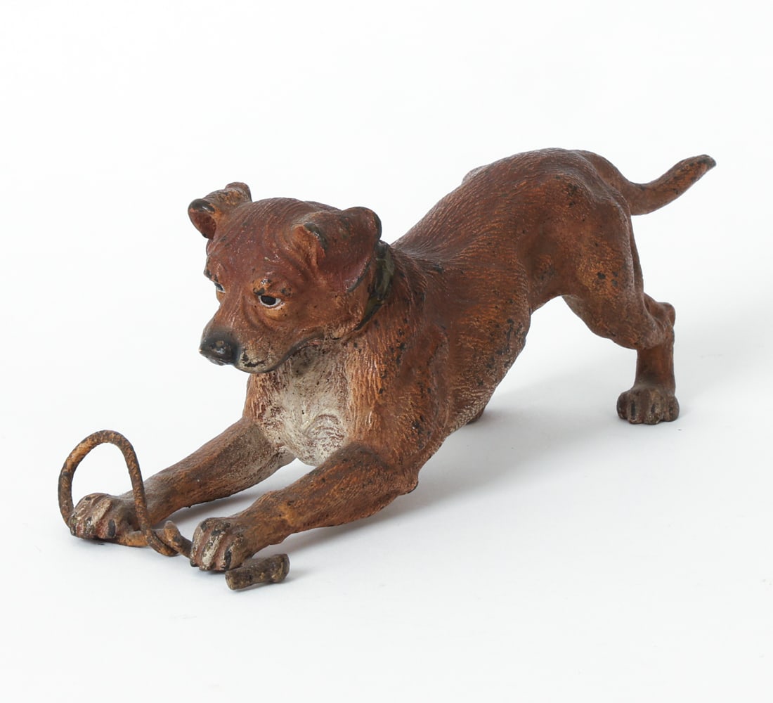 ANTIQUE COLD PAINTED VIENNA BRONZE TERRIER DOG: Apparently unmarked. Bronze figure of a kneeling dog. Late 19th or early 20th century. Dimensions: H 2.5" x W 2.5" x D 7". Condition: Some discoloration including black spots to finish. Minor nick to 