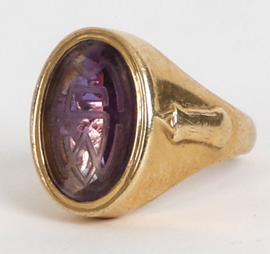 TIFFANY & CO. 14K GOLD & AMETHYST SIGNET RING: Gold ring with amethyst stone to setting. Etched intaglio decoration to stone. Marked to band, with 'Dianne Newton' and date 1941. Included with Tiffany ring box. Dimensions: Box H 1" x W 2.5" x D 1.7