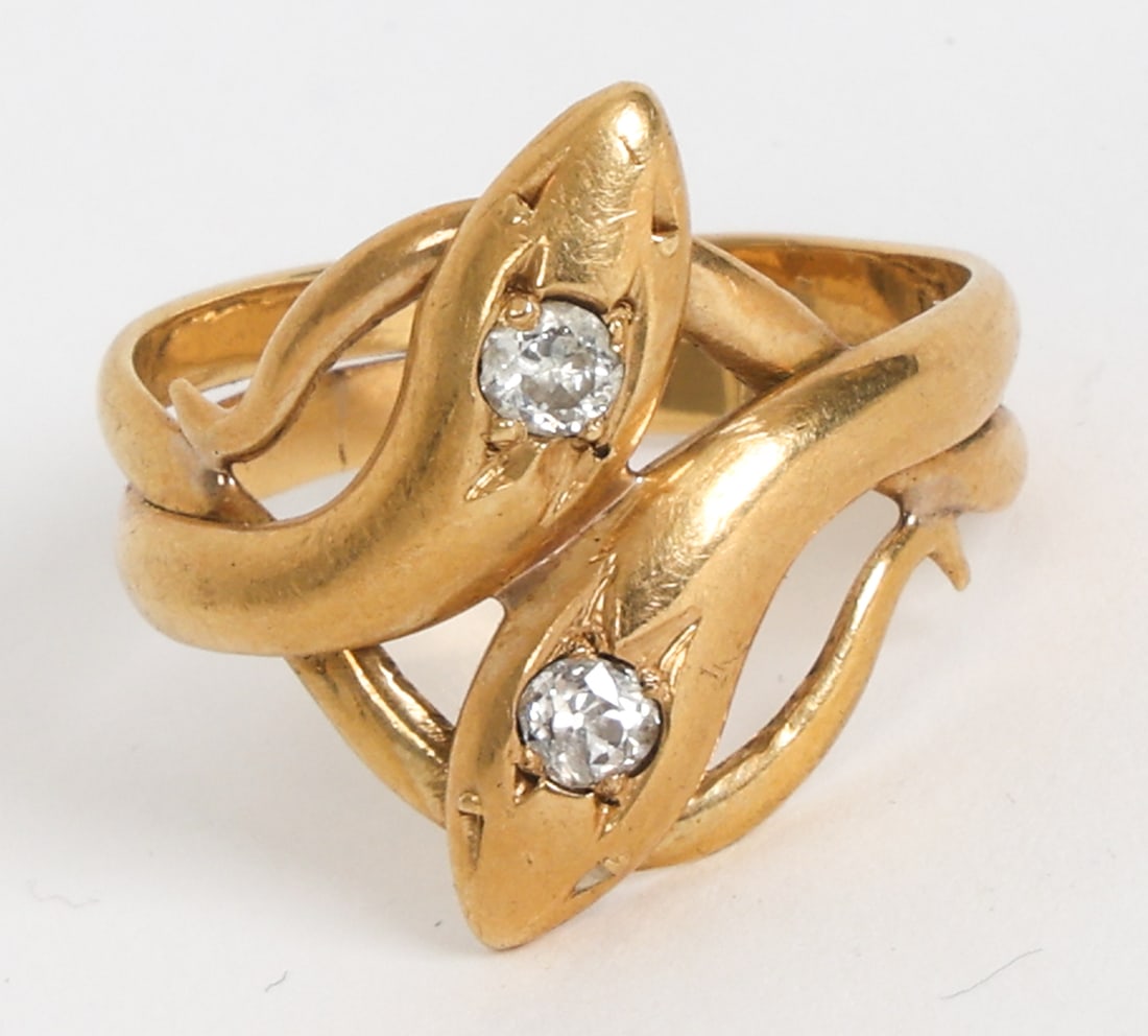 18K GOLD & DIAMOND SNAKE RING: Gold ring with two diamonds. Design of two intertwined snakes. Unmarked, tested. Dimensions: Size 7.75. Condition: Light scuffs and scratches. Wear consistent with age and use.