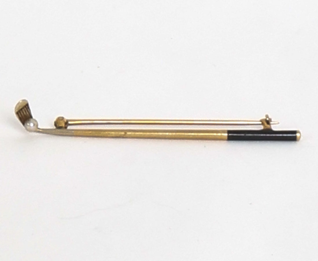14K GOLD GOLF CLUB BROOCH: Gold golf club brooch with pearl adorning the end. Marked to clasp. Dimensions: L 2.25". Condition: Light scuffs, wear consistent with age and use.