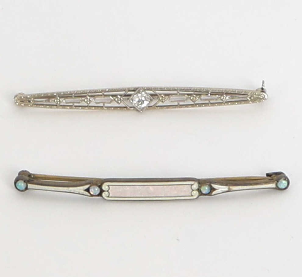 (2) ART DECO WHITE GOLD DIAMOND & SILVER BROOCH: Sterling silver pin with guilloche enamel and opal decoration. Marked to back. Together with 10k white gold and diamond pin. Marked to clasp and tested. Dimensions: Each H 2.25". Condition: Slight tar