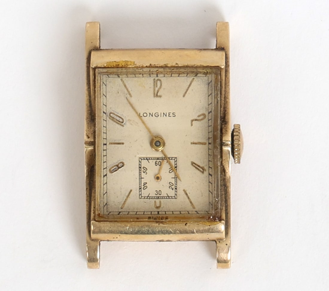 14K GOLD LONGINES DECO WRIST WATCH: Longines watch with gold case. Marked to back. Dimensions: H 1.5" x W 1". Condition: Timekeeping untested. No wrist strap. Scuffs and rubs with slight surface soiling. Wear consistent with age and use