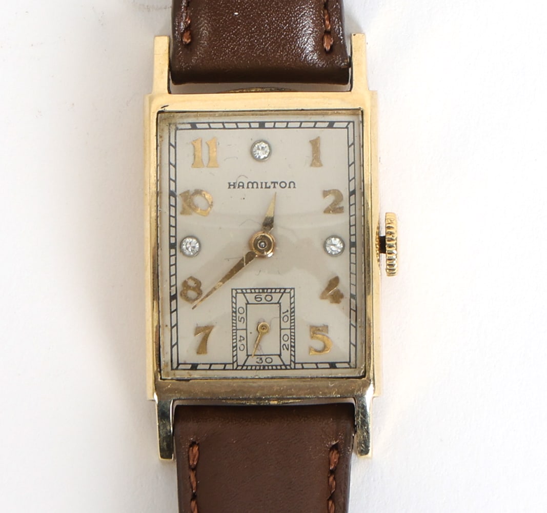 HAMILTON BROCK DIAMOND DIAL 14K GOLD WATCH: Rare Hamilton "Brock" watch with 14K gold case and diamond hour markers at 3, 9, and 12 positions. Calf skin leather strap. Marked to back of case. Dimensions: L 8". Condition: Timekeeping untested. L