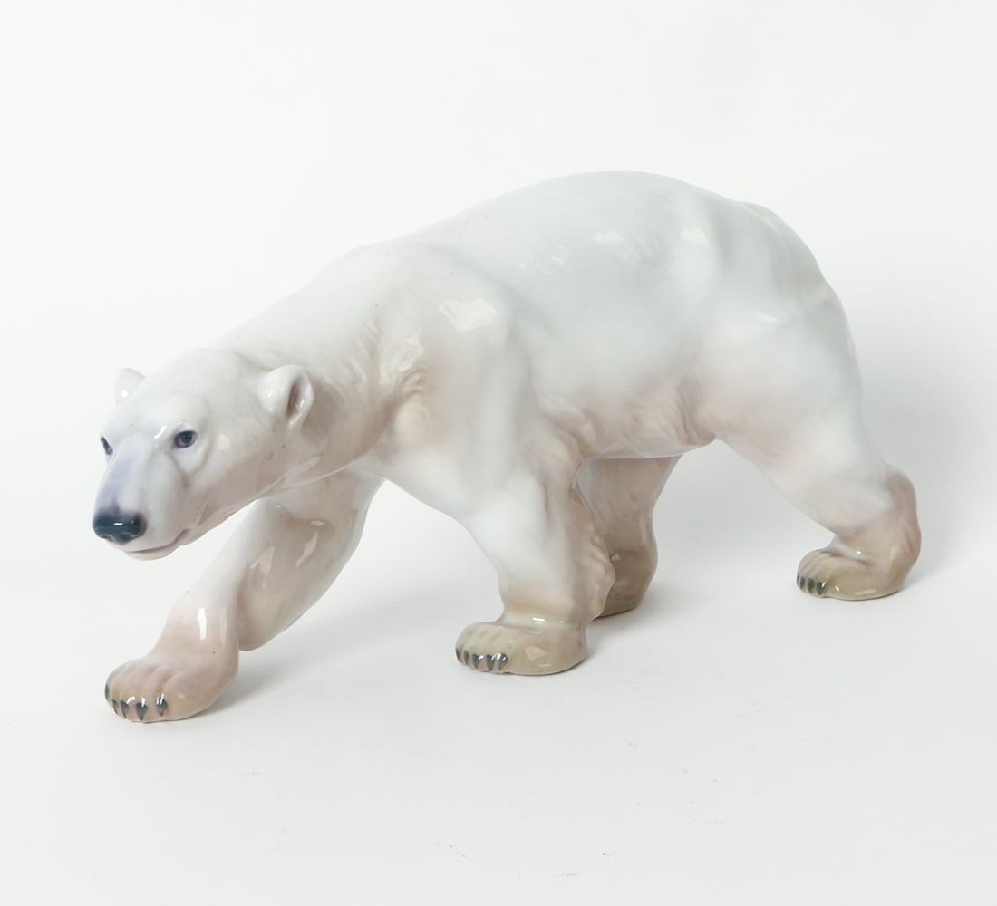 BING & GRONDAHL PORCELAIN POLAR BEAR FIGURINE: Marked underneath. Porcelain ceramic polar bear figure. Denmark, 20th century. Dimensions: H 5.75" x W 3.5" x D 12.25". Condition: Light surface marks. Wear consistent with age and use as displayed.