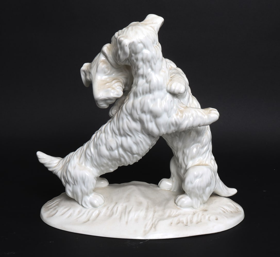 KPM PORCELAIN TERRIER DOGS SCULPTURE: Marked underneath. Porcelain of two terrier dogs hugging. Early 20th century. Dimensions: H 11" x W 11" x D 7.25" Condition: Wear consistent with age and use including minor rubs and scuffs.