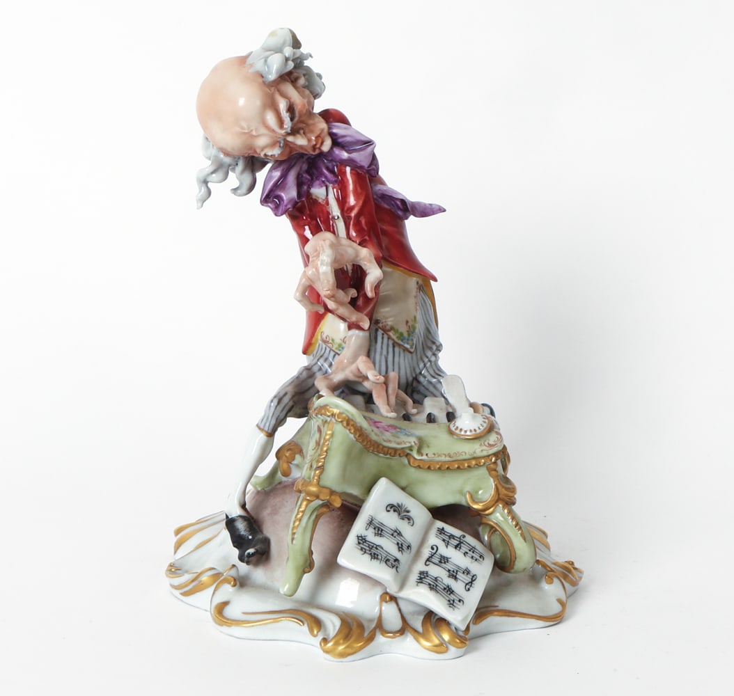 GIUSEPPE CAPPE GROTESQUE PIANIST PORCELAIN FIGURE: Marked Capodimonte underneath. Porcelain figure of a pianist. Dimensions: H 8" x W 6.5" x D 8.75". Condition: Small chip to handkerchief. Surface soiling and rubs. Wear consistent with age and use.