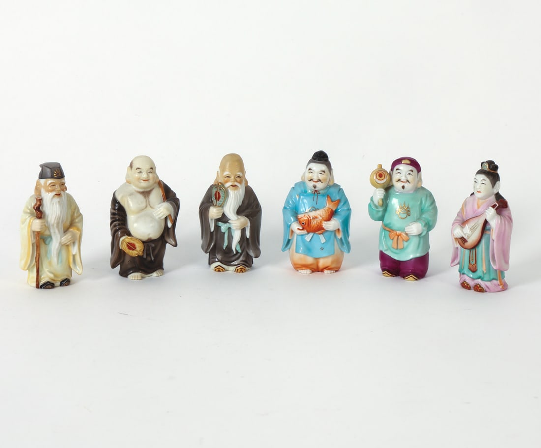 JAPANESE LUCKY GODS OF FORTUNE CERAMIC FIGURES: Grouping of (6) porcelain figures depicting Japanese lucky gods. Marked underneath. Early 20th century. Dimensions: Largest. H 2.75" x W 2" x D 1.5" Condition: Light surface marks. Wear consistent wit