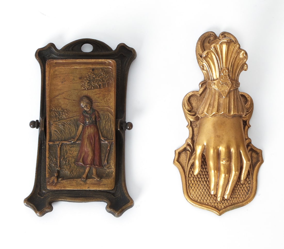 ANTIQUE VICTORIAN BRASS LETTER CLIP HOLDERS: Grouping of two letter holders of varying designs. Hand letter holder marked to front for J&E Ratcliff Birmingham. England, late 19th century. Dimensions: Largest H 5.25" x W 2.75" x D 2.5". Condition