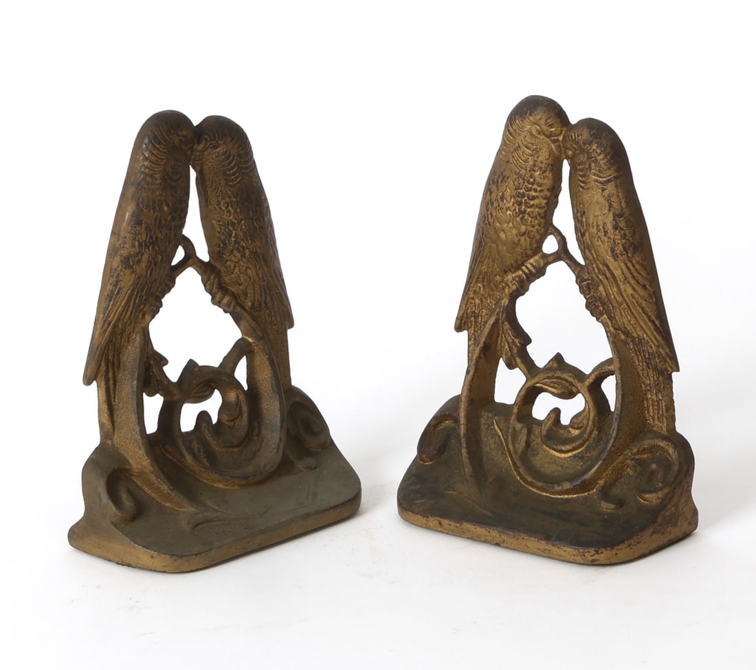 PAIR OF ART DECO LOVE BIRD BOOKENDS: Pair of cast iron bookends in bronze tone finish. Apparently unmarked. Circa 1920s. Dimensions: H 6" x W 4.5" x D 2". Condition: Wear consistent with age and use including minor rubs and scuffs.