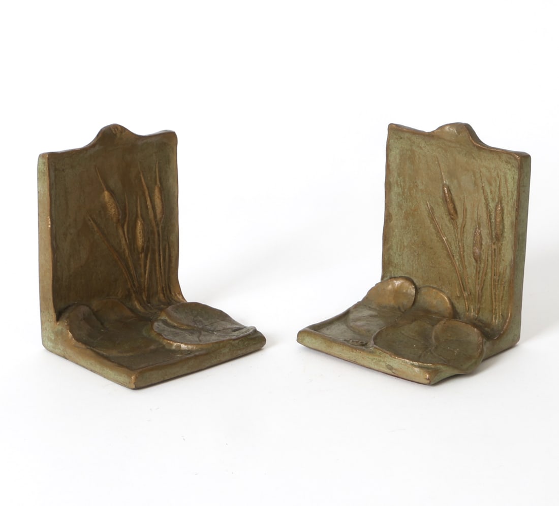 MCCLELLAND BARCLAY ART NOUVEAU BOOKENDS: Pair of bronze bookends with lily pad design. Marked to backs. Circa early 20th century. Dimensions: H 4.75" x W 3.75" x D 3.25". Condition: Wear consistent with age and use including minor rubs and s