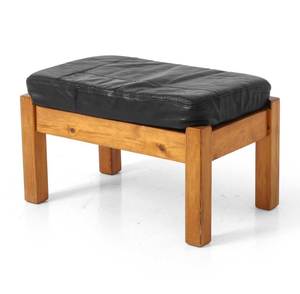 SCANDINAVIAN PINE & LEATHER OTTOMAN: Pine frame in Brutalist style with black leather cushion. Scandinavian, circa 1970s. Dimensions: H 15.75" x W 24.5" x D 15.5". Condition: Scratches and dings to legs. Wear consistent with age and use.