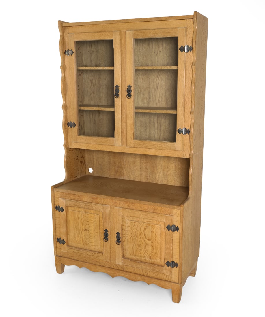 ATTR. HENNING KJAERNULF DANISH OAK CABINET C.1970S: Key included. Brutalist oak hutch cabinet, featuring glass-front upper compartment with adjustable shelving and a lower storage base. Iron hardware. Denmark, circa 1970s. Dimensions: H 72.5" x W 39.5"