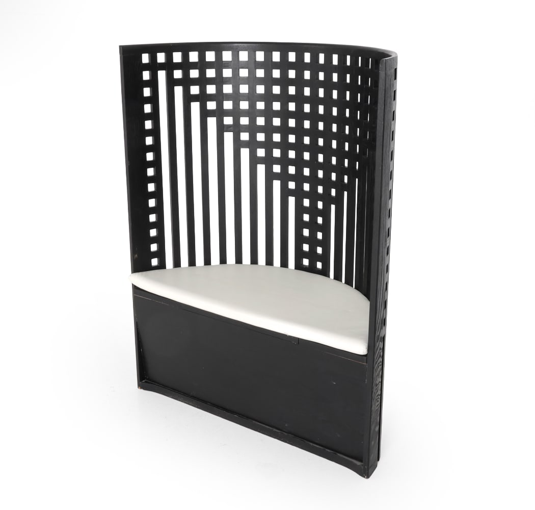 CHARLES RENNIE MACKINTOSH CASSINA WILLOW CHAIR: Ebonized oak lounge chair in the style of Charles Rennie Mackintosh's willow chair. Curved form with tall reticulated back. Storage under the seat. Dimensions: H 47" x W 37" x D 17" DA_22