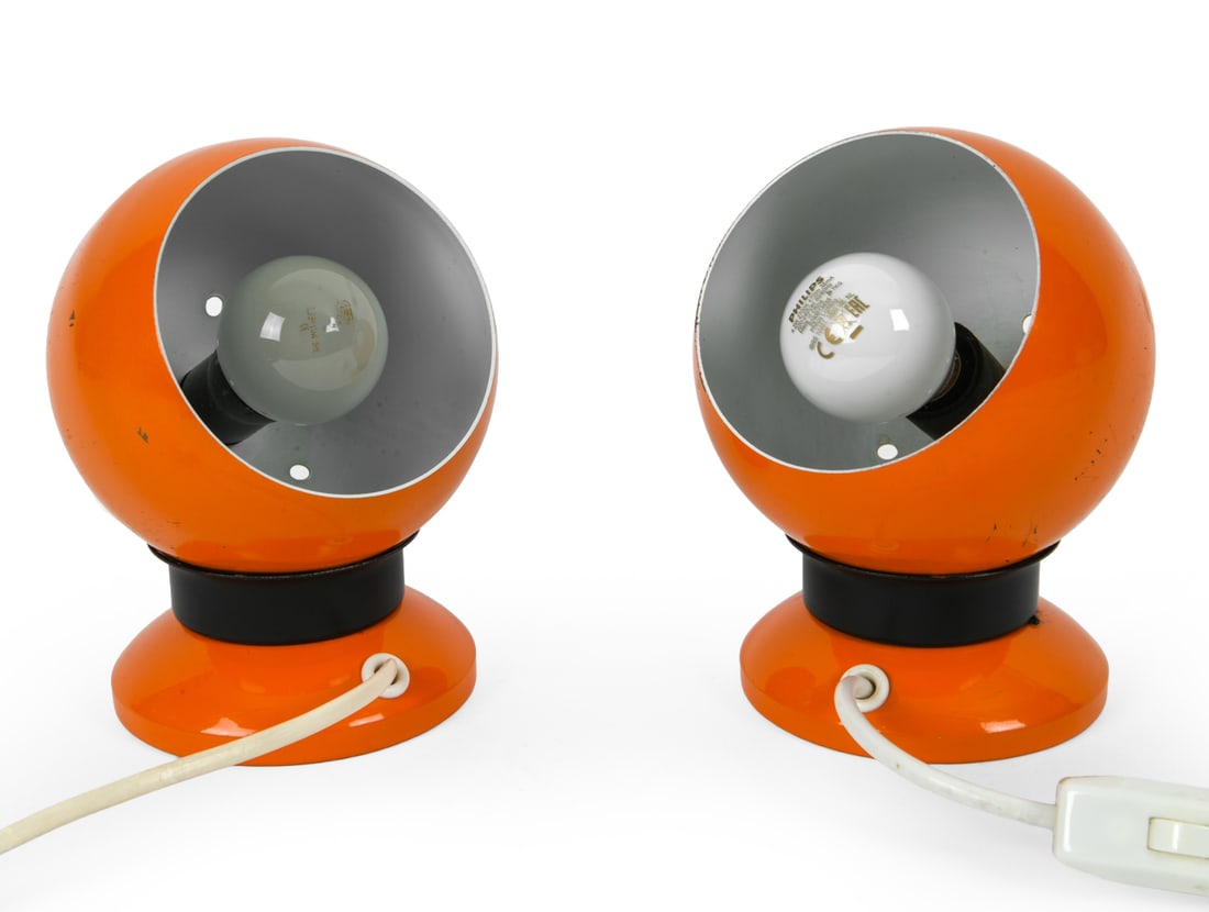 PAIR OF E. S. HORN AALESTRUP EYEBALL LAMPS 1970S: Pair of enameled steel orange space age style eyeball lamps. Labeled on undersides. Denmark. Dimensions: H 6" x W 5" x D 5". Condition: Wiring untested. Scratches and oxidation spots. Wear consistent
