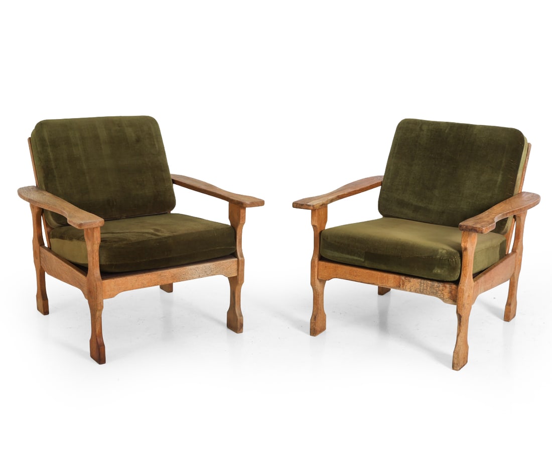 PAIR OF KJAERNULF STYLE DANISH OAK LOUNGE CHAIRS: Two oak lounge chairs with shaped legs and armrests. Green velour upholstered cushions. Denmark, circa 1960s. Dimensions: H 28" x W 23" x D 32" x SH 14" Condition: Watermarks to frame. Fading. Wear co