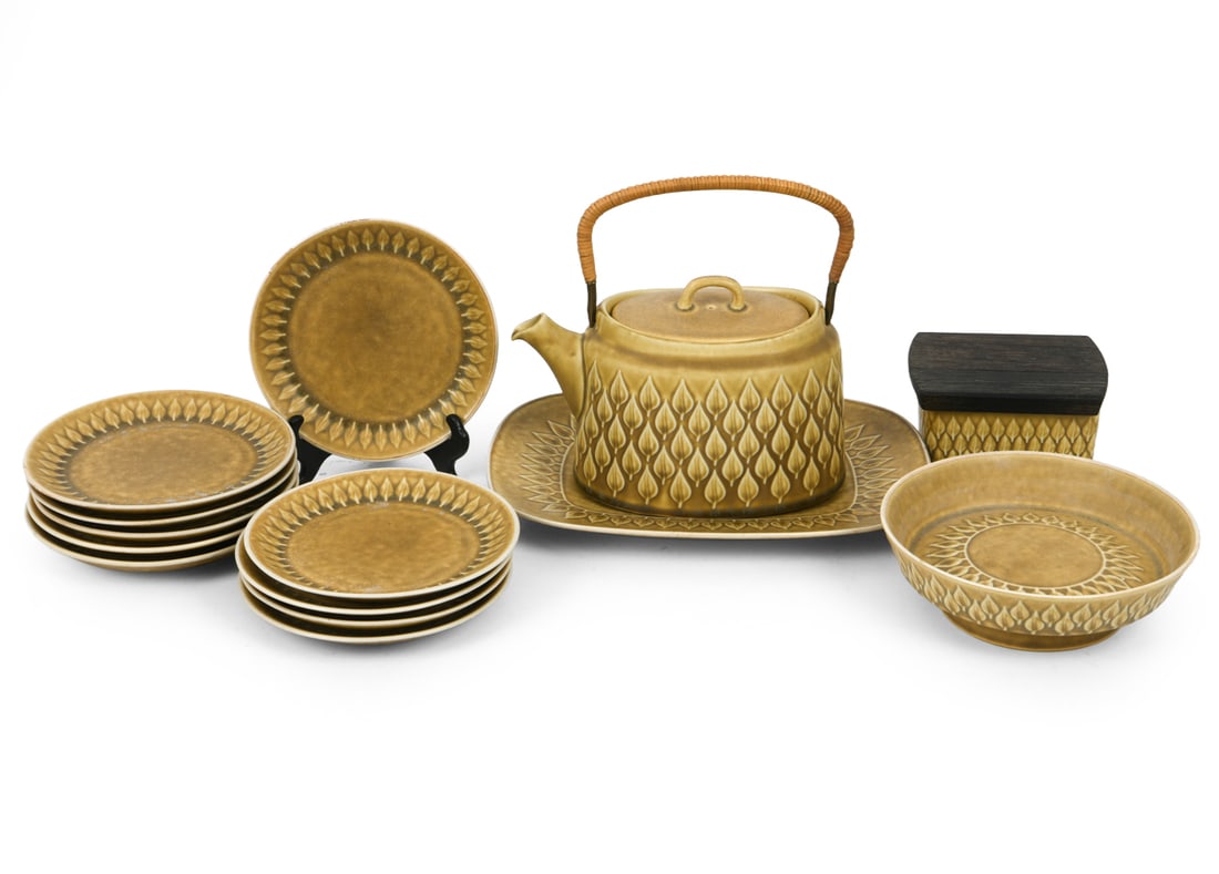 JENS QUISTGAARD RELIEF CERAMIC GROUPING: Marked on undersides. (1) Large plate, (10) small plates, (1) footed bowl, (1) tea pot, (1) wooden lidded bowl. Dimensions: (Pot) H 8.5" x W 8.5", (Largest plate) H 1.25" x W 11.5" x D 8.75" DA_2