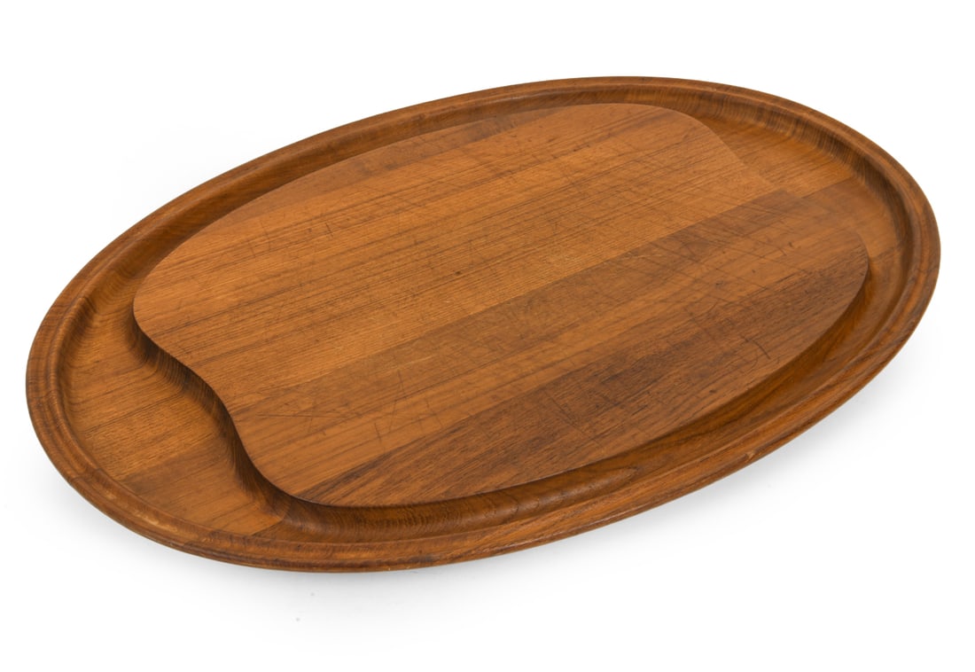 HENNING KOPPEL FOR GEORG JENSEN TEAK CUTTING BOARD: Marked underneath. Dimensions: L 23.75" x W 16.5". Condition: Wear consistent with age and use, including crack and scratches. DA_204