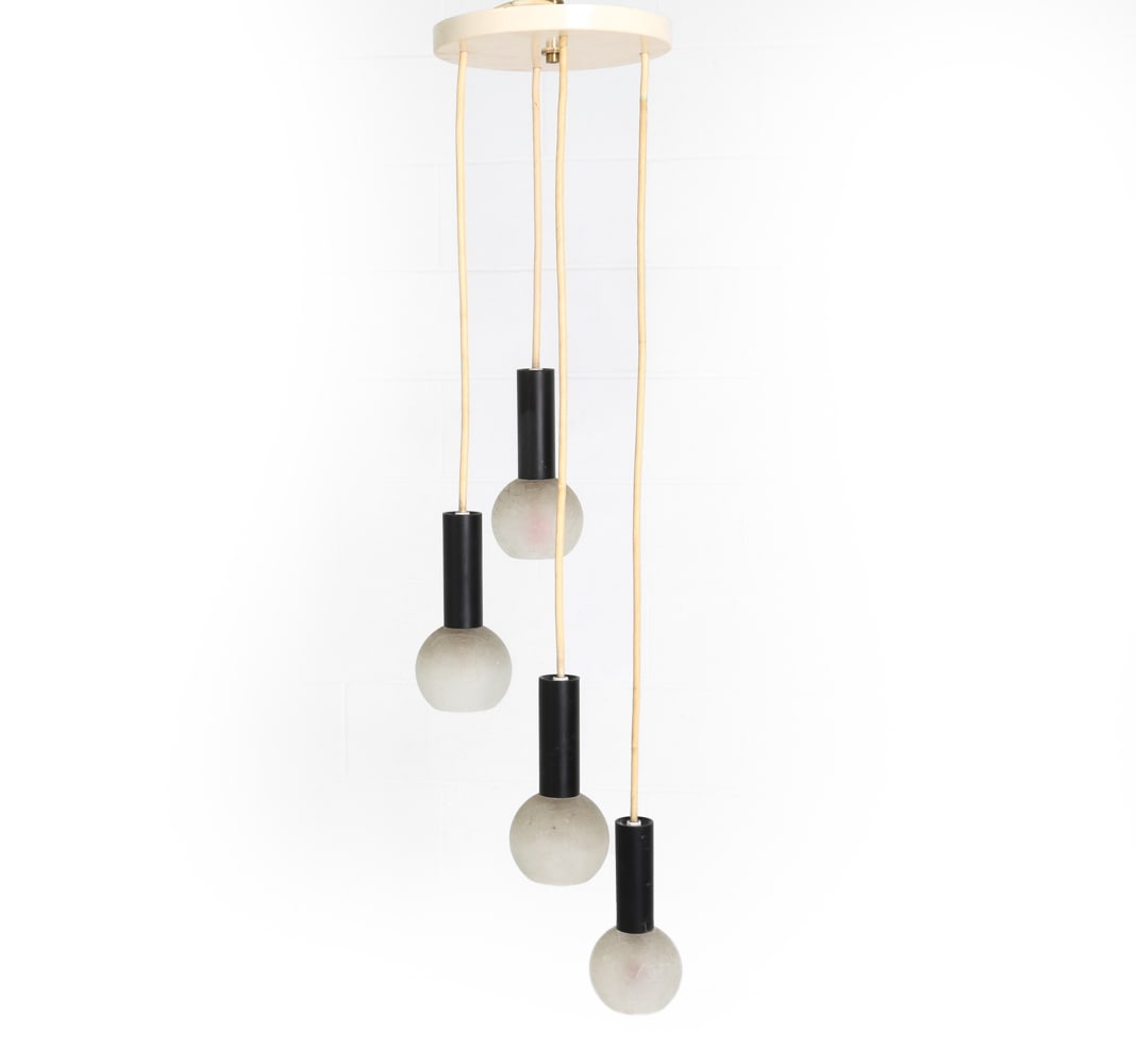 MANNER OF STILNOVO CASCADING CHANDELIER C. 1970S: Four lights with glass globe shades. 20th century. Dimensions: H 45" x Dia. 10.5". Condition: Wiring untested. Light scuffs to metal and glass. Wear consistent with age and use.