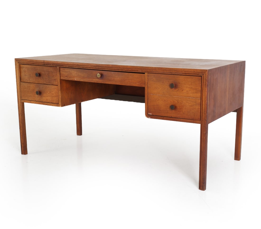 STYLE OF DOMINO MOBLER DANISH TEAK WRITING DESK: Danish teak writing desk with drawers. Round pulls with brass accents. Denmark, circa 1960s. Dimensions: H 29" x W 60" x D 28". Condition: Scratches, scuffs, and dings. Losses to edges and corners. Fa
