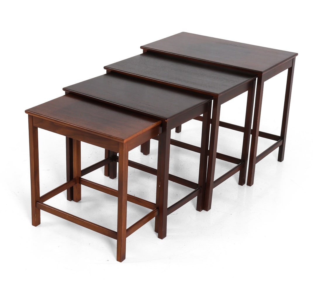 STYLE OF E. W. BACH TEAK NESTING TABLES: Set of (4) teak nesting tables. 20th century. Dimensions: Largest H 21" x W 24" x D 14.25". Condition: Scuffs to edges and corners. Wear consistent with age and use.