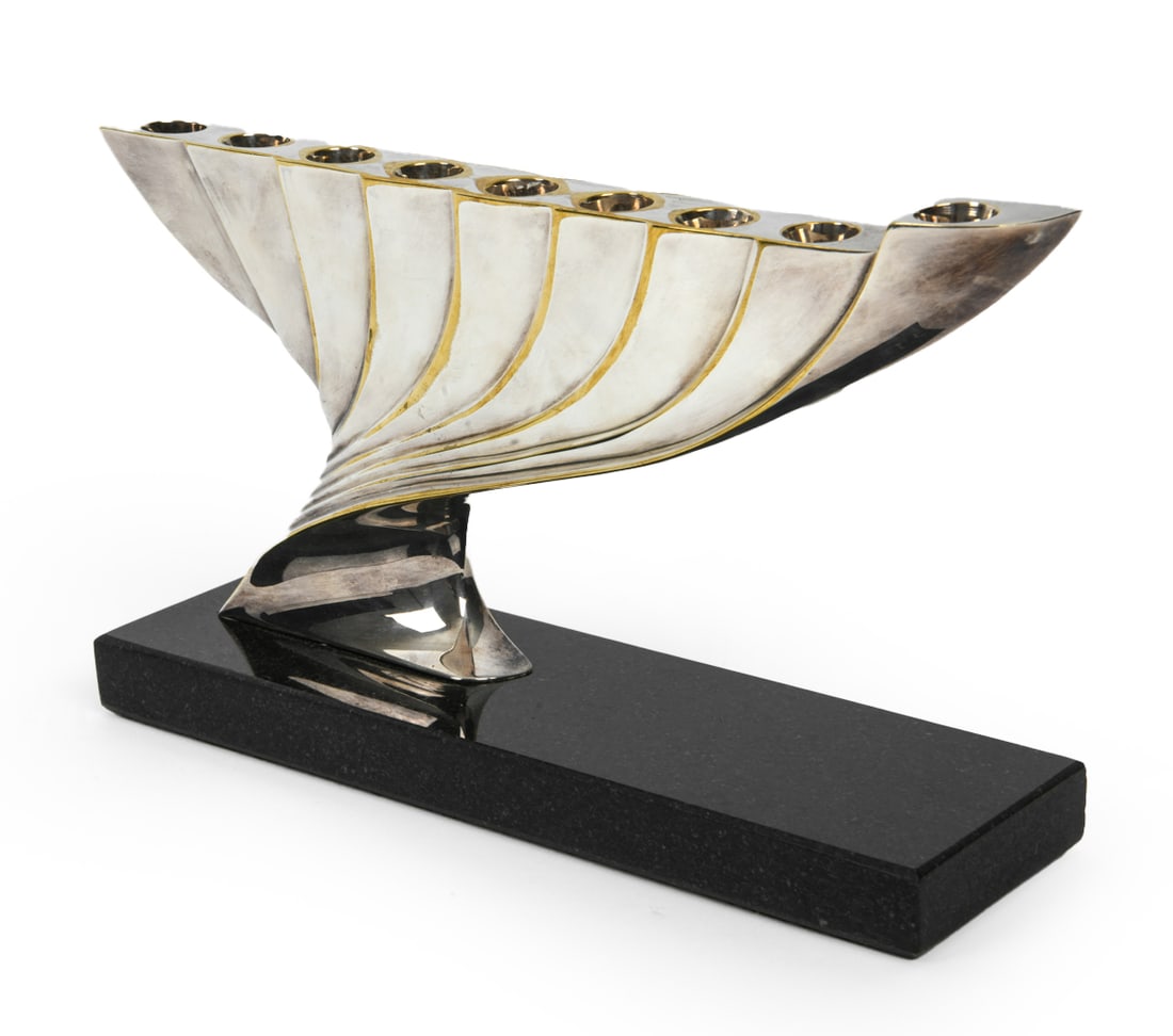 BARUCH SHOHAM (B. 1945) SILVERPLATE MENORAH: Signed and marked to side. Mounted to marble base. Dimensions: H 6" x W 10" x D 3". Condition: Light rubs and scuffs.
