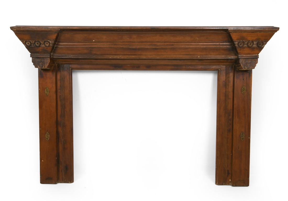 ANTIQUE MAHOGANY FIREPLACE MANTEL: Mahogany fireplace mantel with carved decoration to top molding. Brass accents adorned to sides. Circa 19th century. Dimensions: H 44.5" x W 67.5". Condition: Small losses. Scuffs, scratches, dings.
