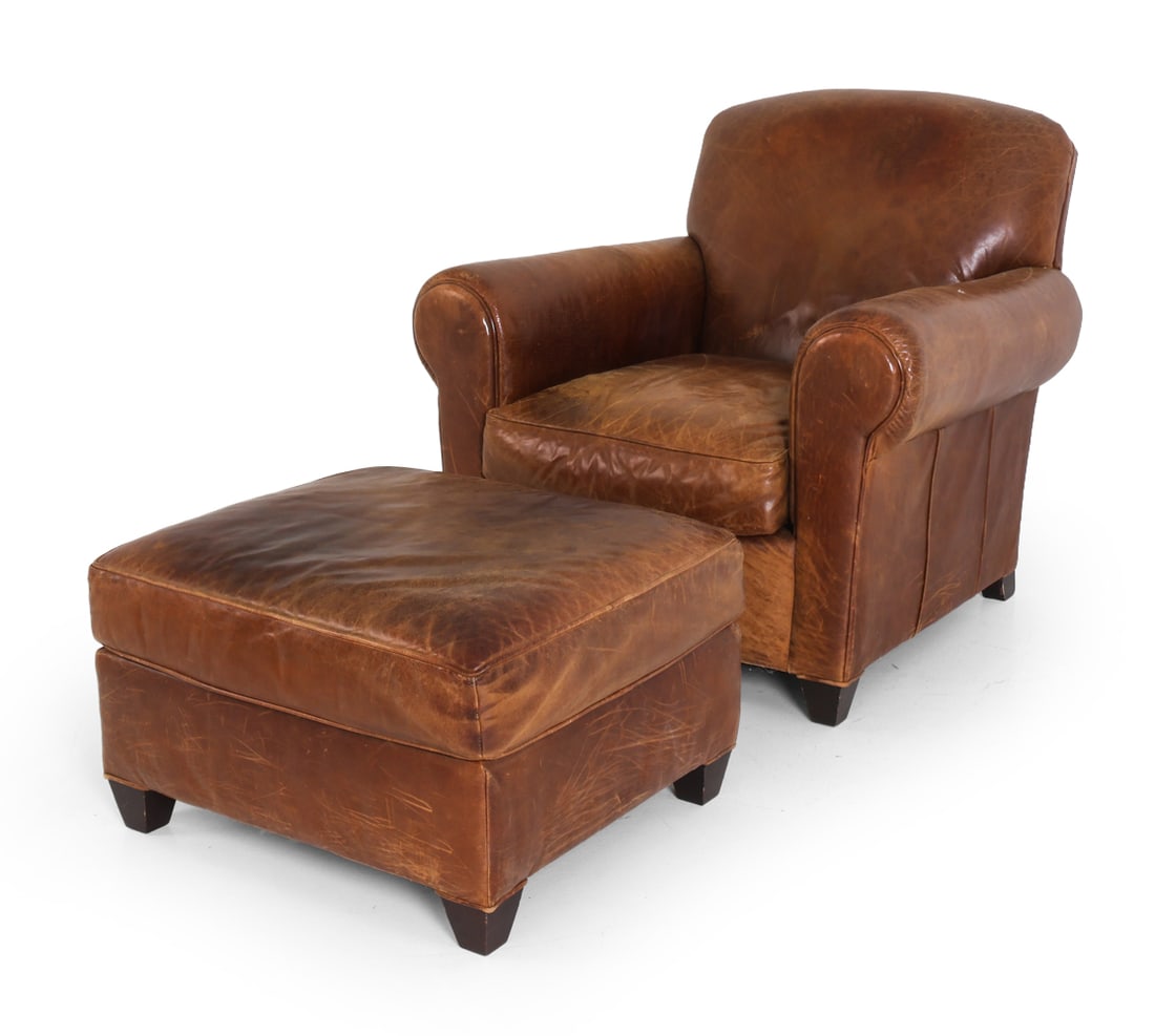 CRATE & BARREL LEATHER LOUNGE CHAIR & OTTOMAN: Marked underneath. Brown leather lounge chair with roll arms. Together with matching ottoman. 20th century. Dimensions: Chair H 34.5" x W 35.5" x D 35" x SH 16.75". Ottoman H 16.25" x W 26.5" x D 22.5