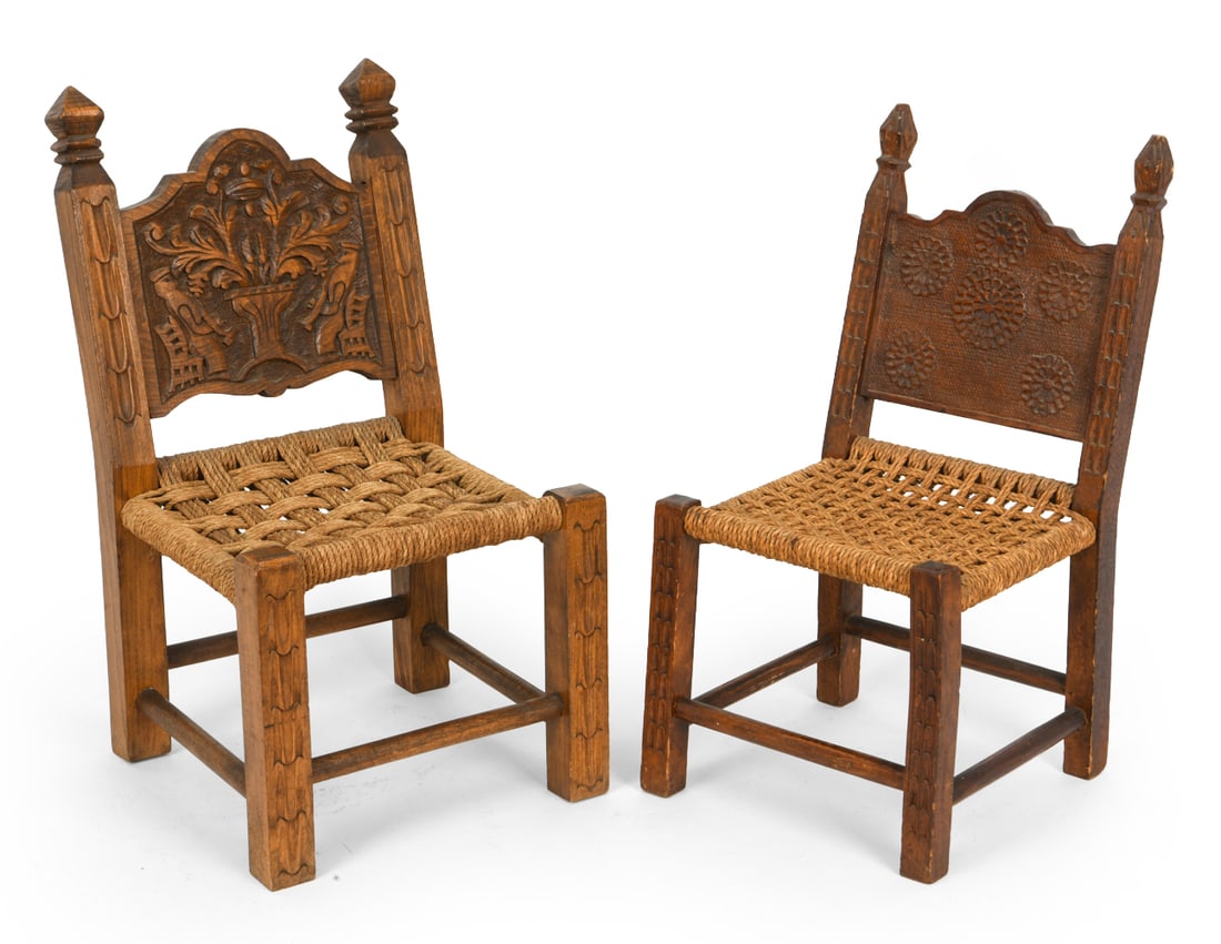 CARVED OAK CHILDRENS CHAIRS: Two wooden chairs with woven rush seats. Carved decoration to frames and seat backs. Early 20th century. Dimensions: Largest H 19.75" x W 11.25" x D 10.75" x SH 9.25". Condition: Scuffs and rubs to