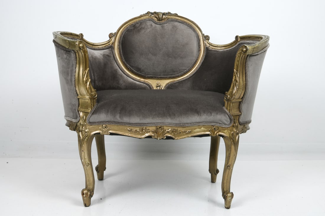 FRENCH LOUIS XV STYLE GILTWOOD BERGERE CHAIR: Giltwood frame with grey velour upholstery. Dimensions: H 32" x W 35" x D 22" x SH 17.75". Condition: Losses to paint. Previous repairs and stress cracks. Wear consistent with age and use.
